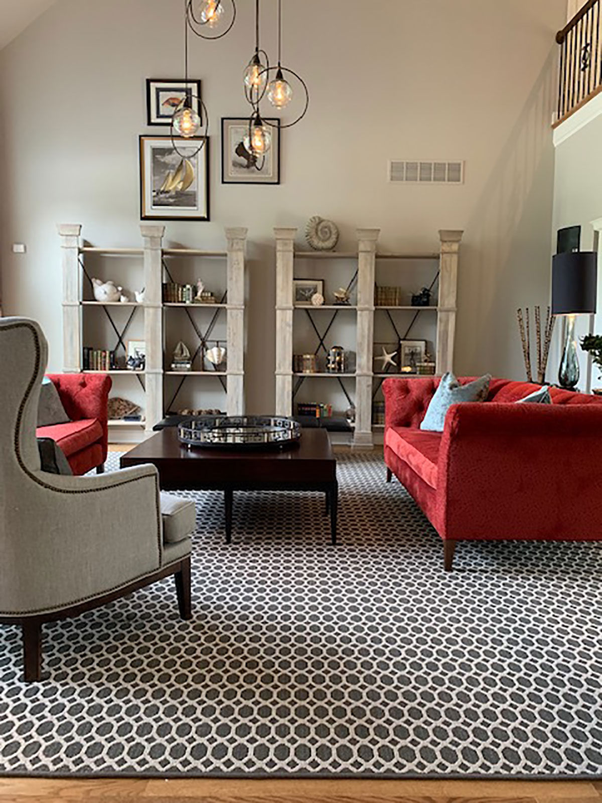 living room with bold furniture and grand bookcases