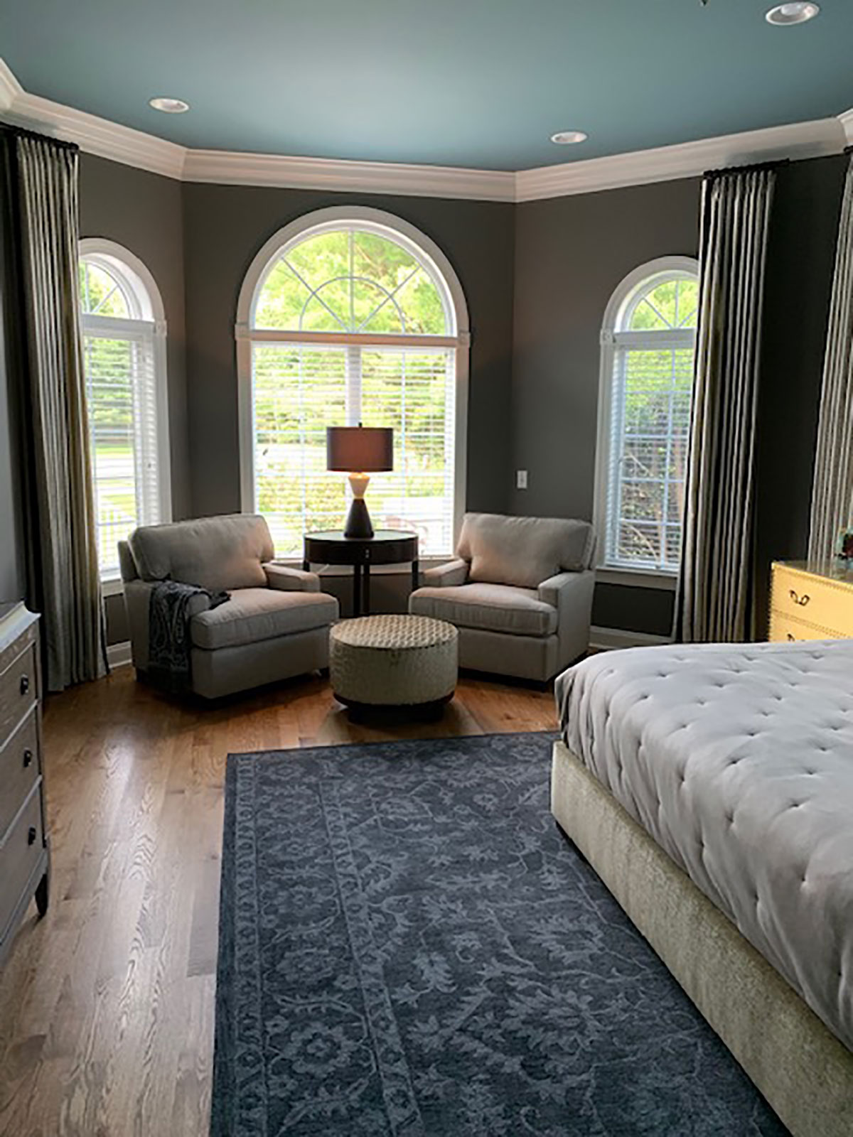 bedroom nook with large windows and comfortable sitting area