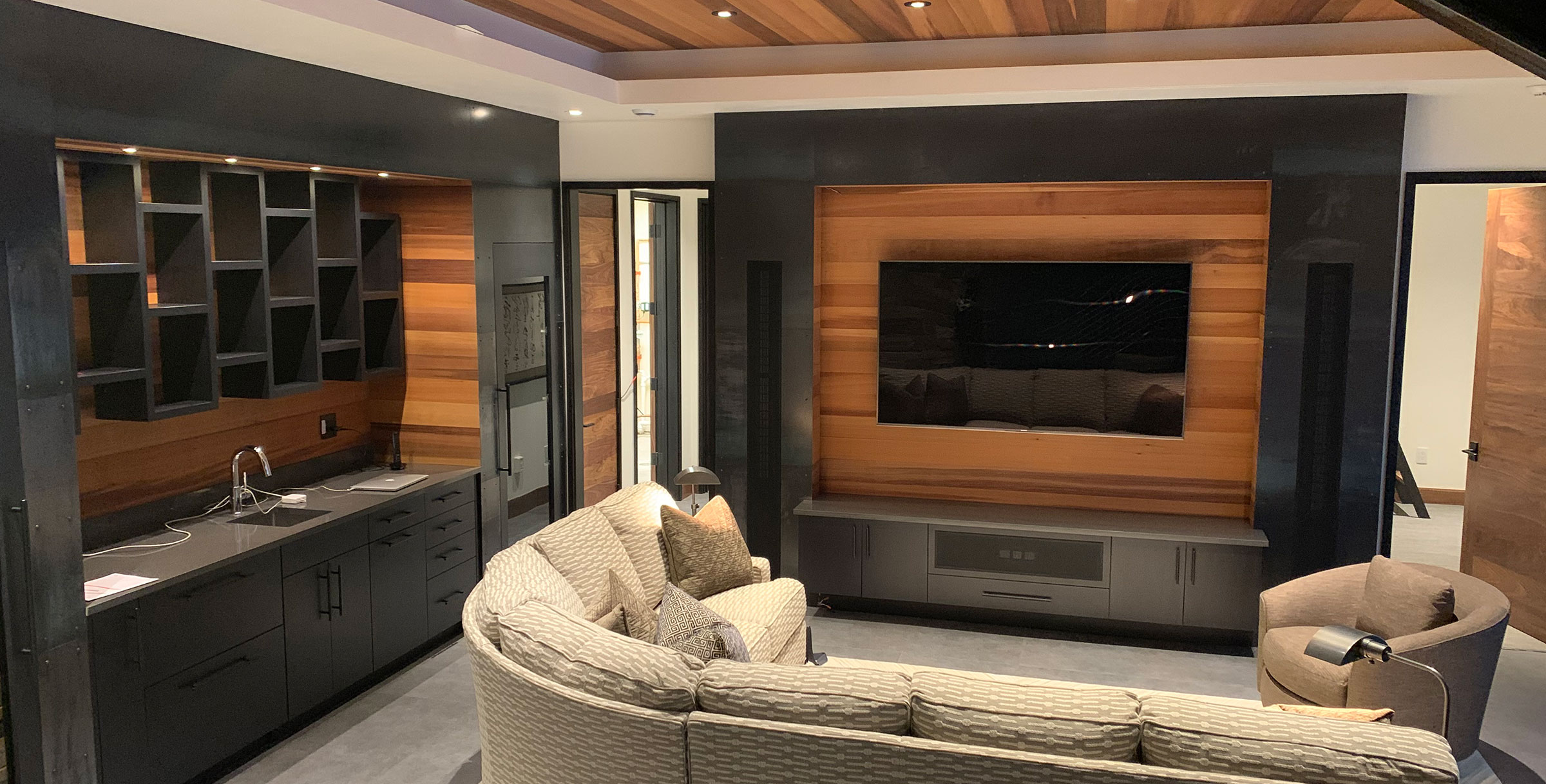 modern entertainment room with kitchenette and bar