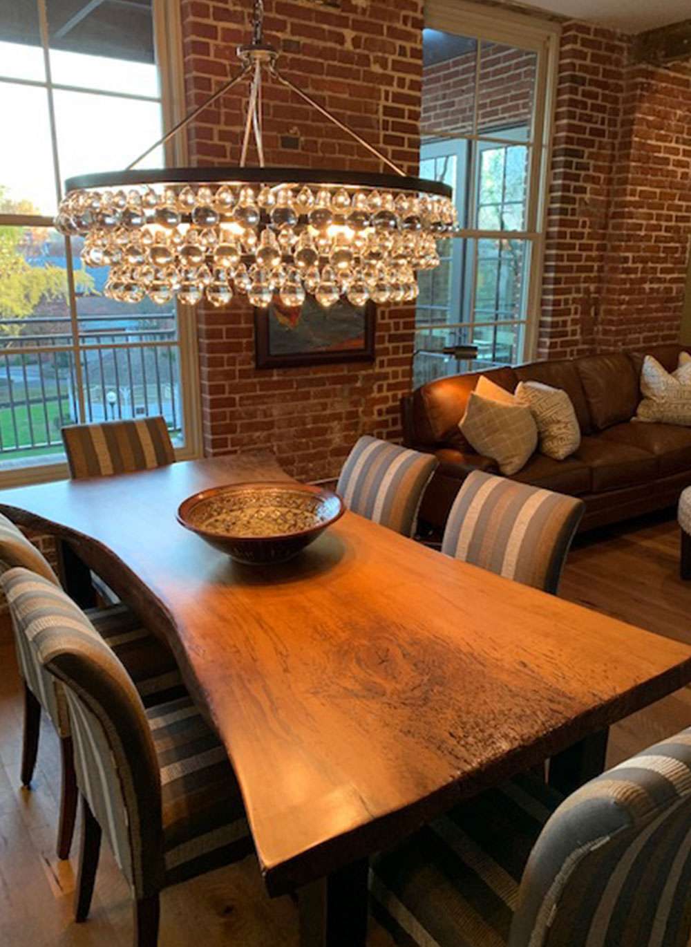 crystal chandelier over custom crafted wood dining room table