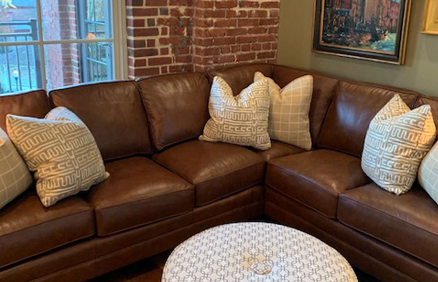 leather sectional with modern throw pillows and settee